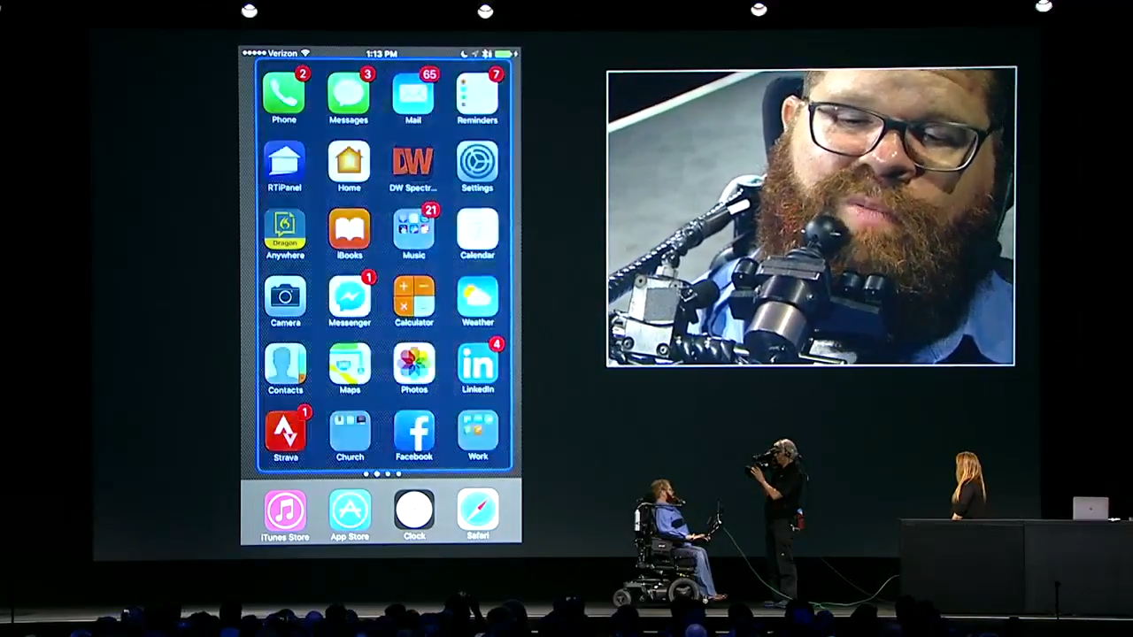 Man in wheelchair presenting on stage