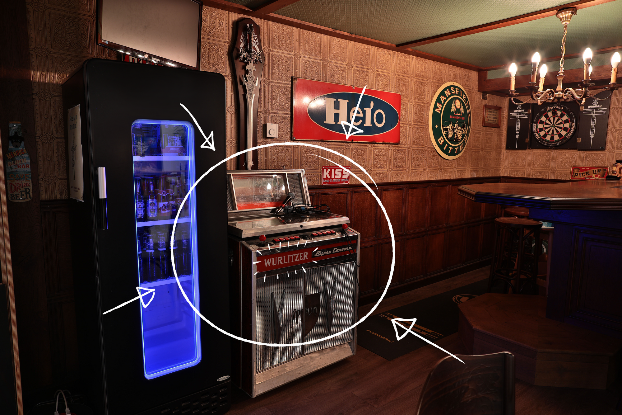 Picture of a traditional English style wooden pub bar with an old Wurlitzer jukebox. 