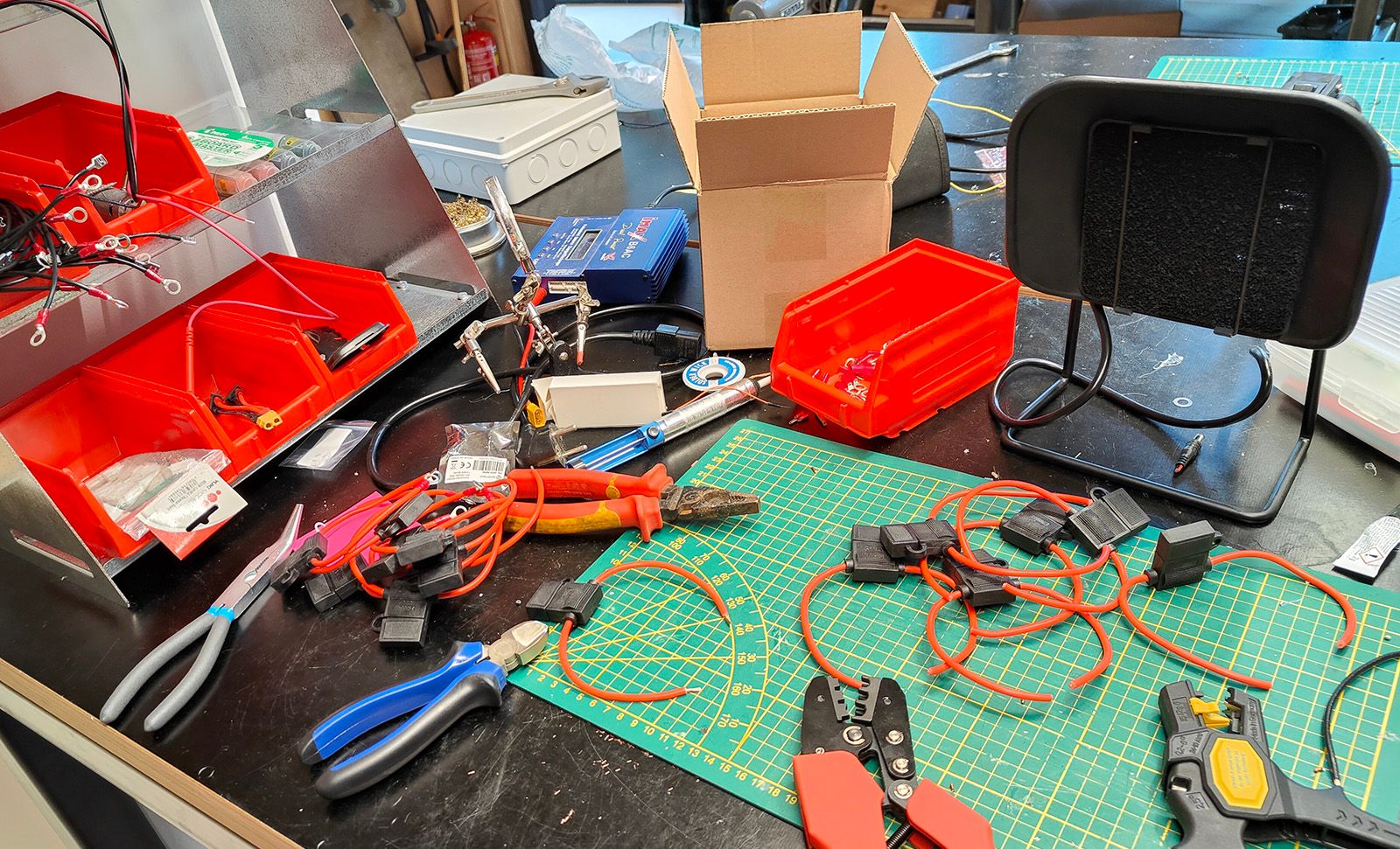 Workbench with tools and wiring looms.